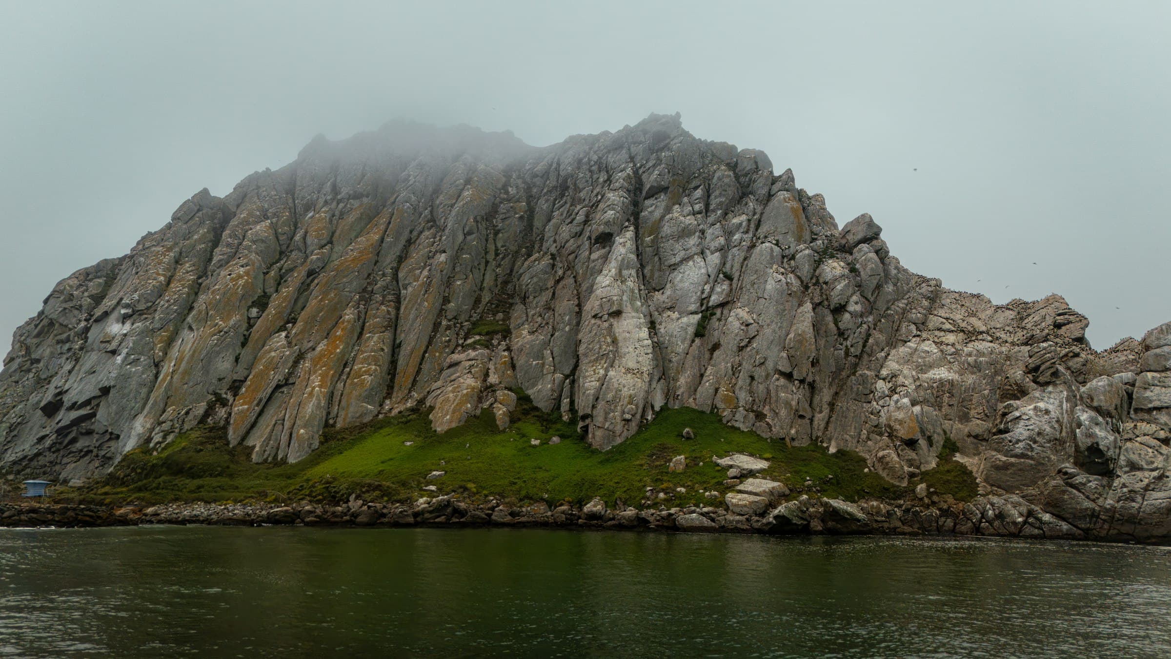 Morro Rock rising out of coastal fog, Morro Bay, California